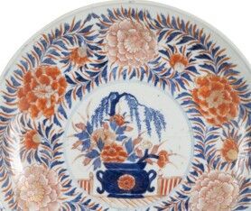 null Circular porcelain dish with Imari decoration of a flowering vase on a terrace,...