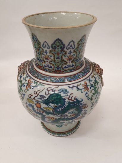 null A baluster vase with a high flared heel in porcelain and doucai enamels decorated...
