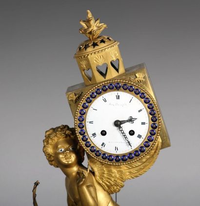 null PENDULE en bronze ciselé et doré représentant «L'amour chasseur d'étoiles»,...