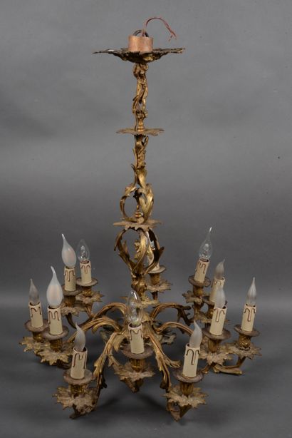 null Chased bronze chandelier with 12 arms of light and foliage decoration, H. 80...