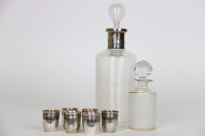 null Meeting of a glass carafe with a solid silver neck, and an opaque glass bottle...