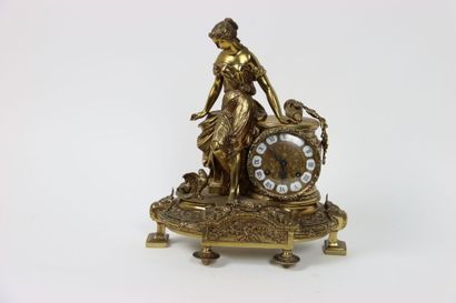 null In the Louis XVI style. Clock in gilt bronze decorated with a woman in the antique...