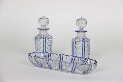 null Attributed to BACCARAT. Set of toilet in molded crystal heightened with blue...