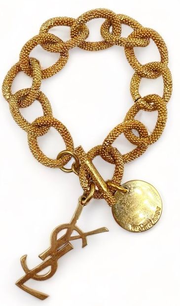 Yves SAINT LAURENT Beaded mesh bracelet
Gilded metal
1 signed circular charm
1 charm...