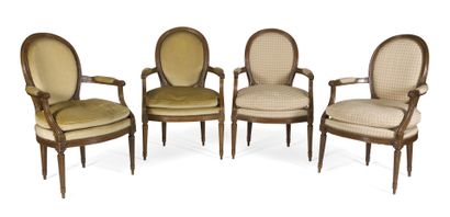 null Suite of four armchairs 
with cabriolet medallion backs in molded beech and...