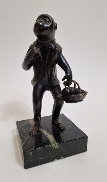 null Brown patina bronze okimono depicting a monkey dressed in haori, standing and...