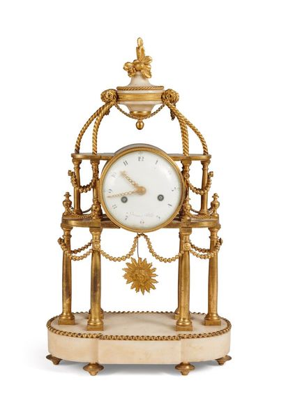 Pendule portique Portico clock in chased ormolu and white marble. The white marble...