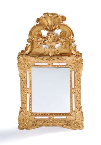null Glazed mirror 
In gilded wood, topped by a pediment decorated with palmettes,...
