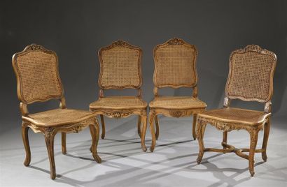 null Set of four walnut chairs moulded and carved with flowers and foliage, back...