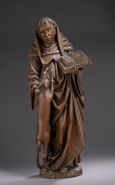 null SAINT GILLES in oak carved in the round. Standing, holding an open book in his...