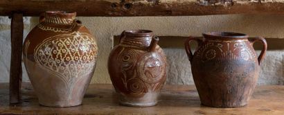 null Three red earthenware potteries with white engobe decoration under a lead glaze....
