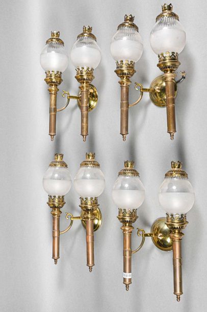 null Set comprising four double quinquet wall lights in brass. Opalescent glass lampshade...