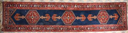 TAPIS GALERIE with geometrical patterns on a blue background and brown counterfeit...