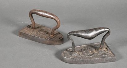 null Pair of cast iron and wrought iron irons decorated with two hearts in a stoup...