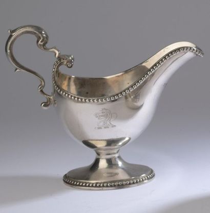 null Plain silver gravy boat resting on a pedestal engraved with a crest (horse)...