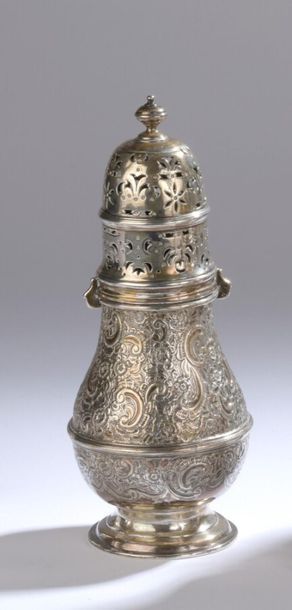 null A silver baluster-shaped sprinkler on a pedestal. The body is decorated in repoussé...
