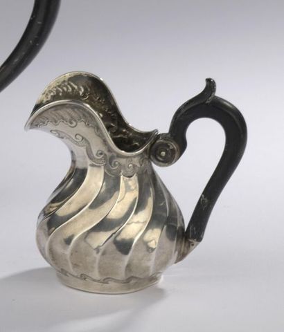 null Silver creamer in the form of a baluster with a decoration of torsos ribs and...