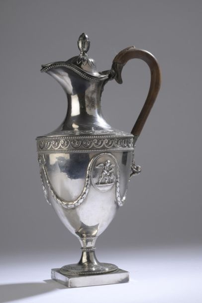null Silver ewer resting on a square base, decorated with two oval medallions adorned...