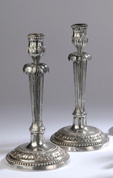 null Two torches forming a silver pair on a monogrammed round base, decorated in...