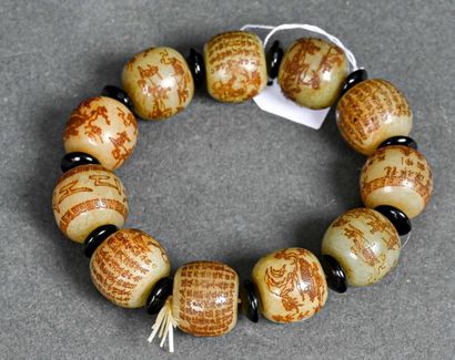 null CHINE - Vers 1900
Bracelet bouddhique formé de onze perles de jadéite céladon,...