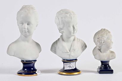 null LIMOGES Three busts of children in bisque on blue and gold enamelled pedestal.

H....