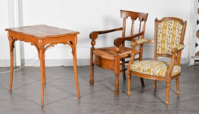 null Art Nouveau table, a Louis XVI armchair and a straw armchair