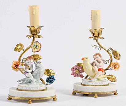 null Pair of Porcelain candleholders with angels on birds and flowers decoration...