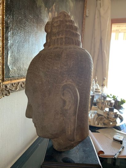 null Khmer styleGrey sandstone Lokeshvara head, eyes closed, conical headdress with...