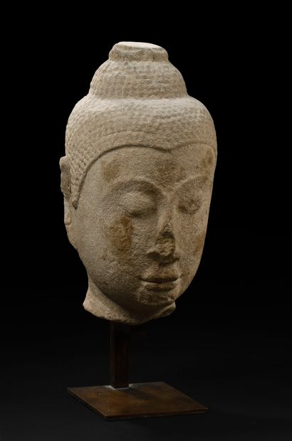 null THAILAND - 15th century

Head of Buddha in grey sandstone, the headdress surmounted...