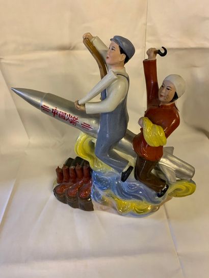 null Porcelain group featuring two young Chinese revolutionaries riding a missile.

China,...