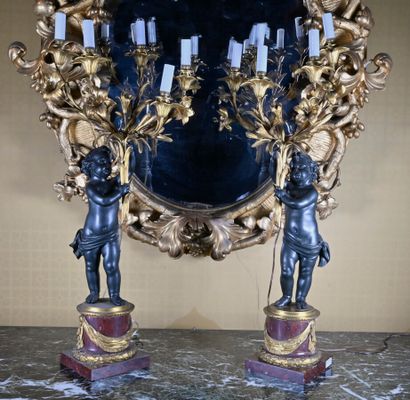null Pair of gilt patinated bronze candelabra decorated with two putti holding branches...
