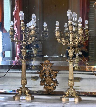 null Pair of bronze candelabra with four arms of light, resting on an indented base...