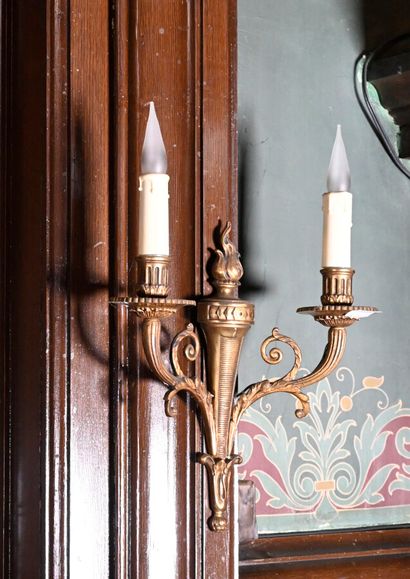 null Suite of four ormolu sconces decorated with flaming torches with two light arms...