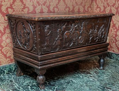 null Slightly flared walnut case, carved with battle scenes. Mobile base with baluster...