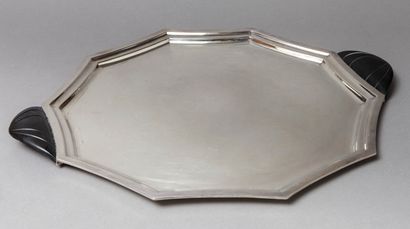 null Octagonal tray with curved sides, in moulded silver metal with two solid triangular...