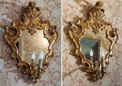 null Pair of giltwood mirror-appliques carved with palmettes, shells, with a bronze...