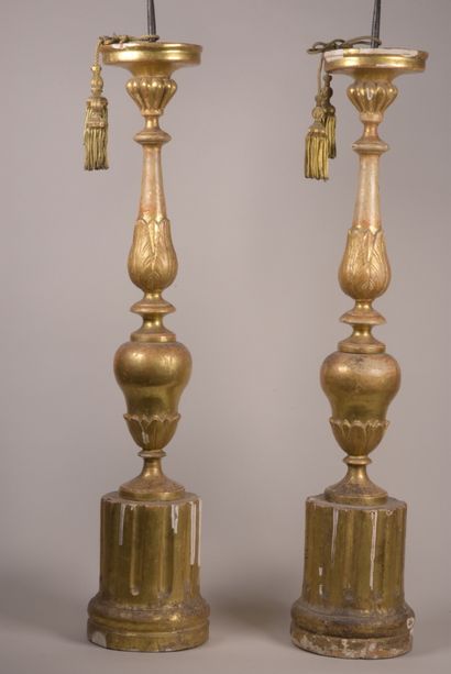 null A pair of wood and gilded stucco pedestal tables, the baluster shaft decorated...
