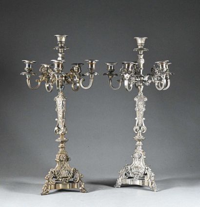null Pair of six-light silver-plated candlesticks, the shaft sheathed, the tripod...