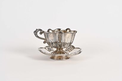 null Large cup on pedestal and its saucer with pinched sides, plain panels interspersed...