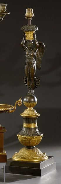 null Important ormolu and patinated torch shaft with a winged woman carrying a basket...