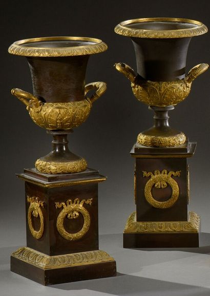 null A pair of ormolu and patinated Medici vases on a square base decorated with...