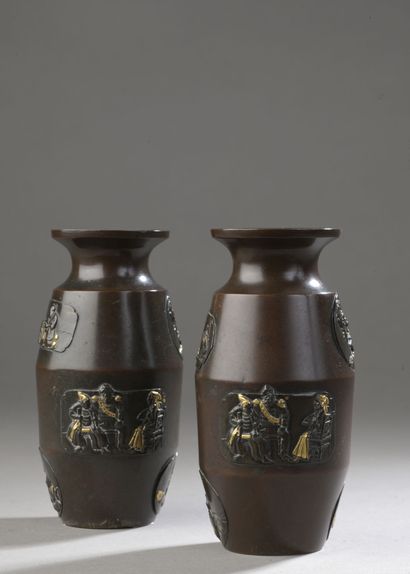 null Pair of small bronze vases with relief decoration with gold highlights, in medallions...
