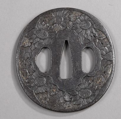 null Two iron tsuba maru gata, one with chased chrysanthemum decoration, the other...