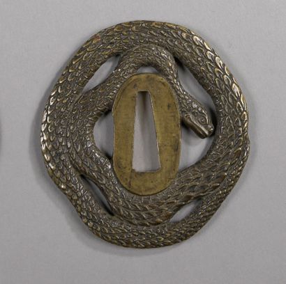 Brass tsuba in the shape of a coiled snake....