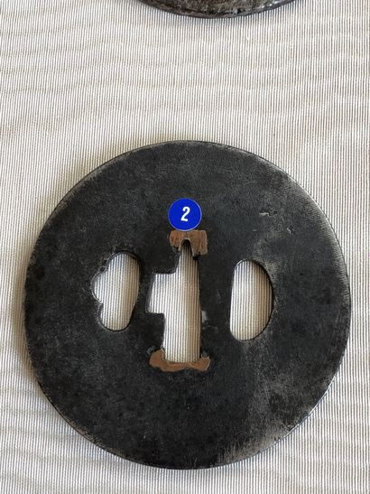 null Two iron tsuba maru gata, one with stamped decoration of clouds and stylized...