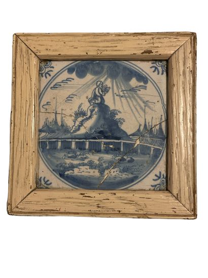 null Delft earthenware tile with blue decoration in a wooden frame depicting Moses...