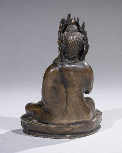 null CHINA/TIBET, early 20th century

A bronze embossed Buddha seated in padmasana...