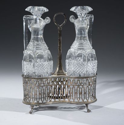 null Silver oil and vinegar cruet with openwork body, resting on four claw feet,...