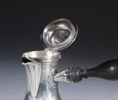 null Baluster coffee pot in plain silver with a straight ebony handle; it rests on...