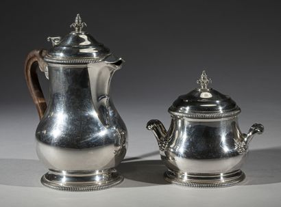 null A silver pourer and a covered sugar bowl, of baluster form, decorated on the...